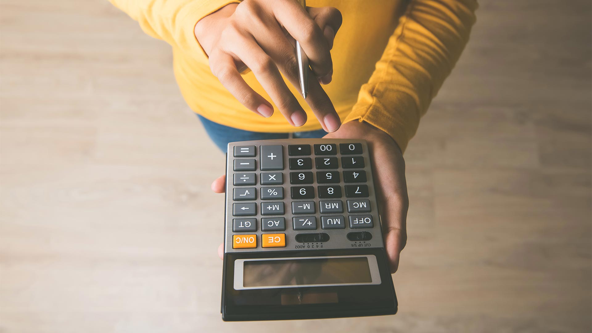 Person using calculator to work out WACC