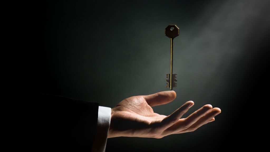 Person holding hand underneath key