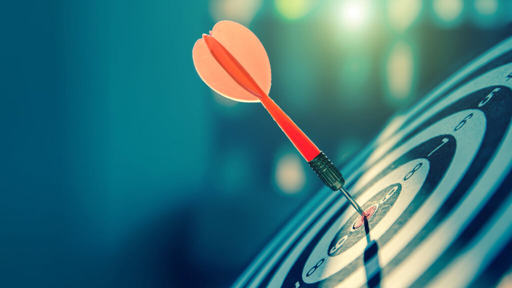 Target board with a dart in the bullseye