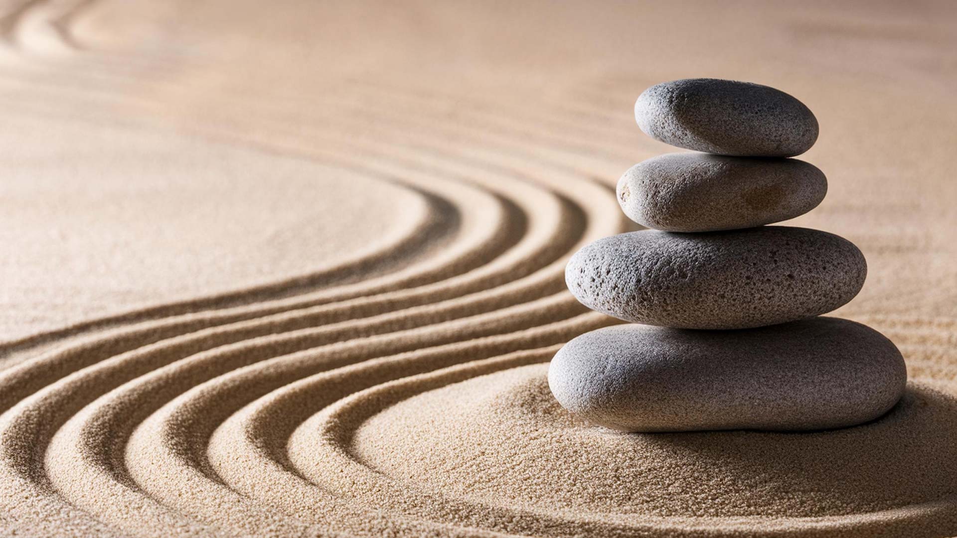Japanese zen garden with stacked stones and raked sand