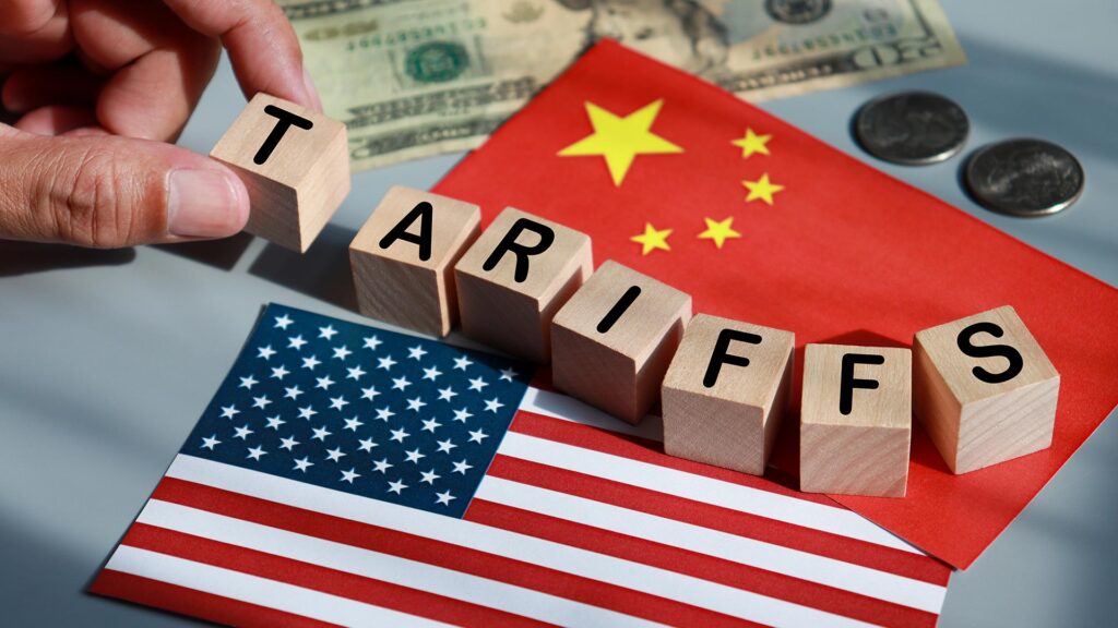 US and China flag with tariffs block letters on top