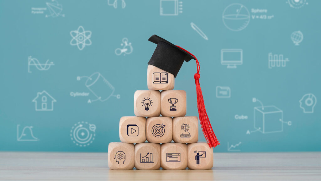 Education learning concept with wooden cubes and a graduation hat