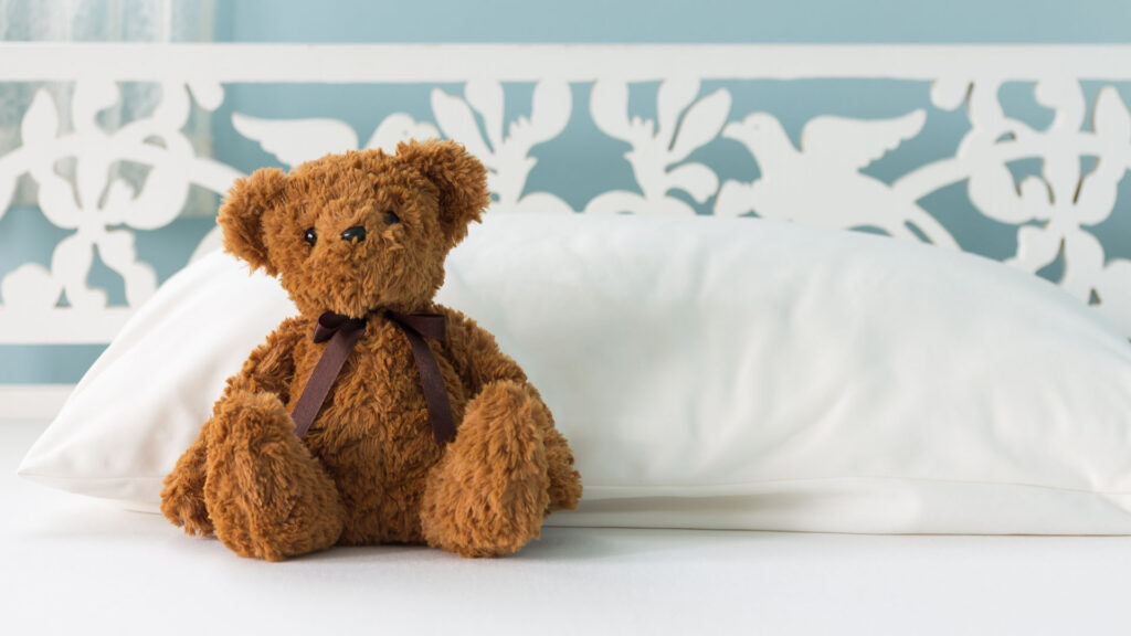 Plushie on a hotel bed